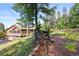 Exterior view of house surrounded by towering trees at 29825 Kennedy Gulch Rd, Conifer, CO 80433