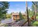 Charming multi-story home featuring wood siding and a spacious deck at 29825 Kennedy Gulch Rd, Conifer, CO 80433
