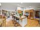 Bright kitchen with wood cabinets, a tile countertop island, and views into the living room at 29825 Kennedy Gulch Rd, Conifer, CO 80433