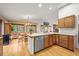 Bright and spacious kitchen with light wood cabinets, stainless steel appliances, and hardwood floors at 29825 Kennedy Gulch Rd, Conifer, CO 80433