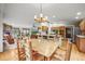 Open concept living space with a wood dining table, living room, and kitchen island at 29825 Kennedy Gulch Rd, Conifer, CO 80433