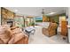 Spacious living room with comfortable seating, a stone fireplace, and access to the outdoors at 29825 Kennedy Gulch Rd, Conifer, CO 80433