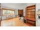 Open living room with beautiful hardwood floors and a large window that provides natural light and scenic views at 29825 Kennedy Gulch Rd, Conifer, CO 80433