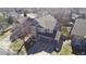 Aerial view of a well-maintained home with a two-car garage and a beautifully landscaped lawn at 11722 W Belmont Pl, Littleton, CO 80127