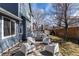 Beautiful backyard featuring a patio with modern chairs and a well-maintained lawn with access to a deck at 11722 W Belmont Pl, Littleton, CO 80127