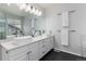 Modern bathroom with double sinks, granite countertop, and bright lighting at 11722 W Belmont Pl, Littleton, CO 80127
