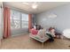 Bright bedroom with cloud decorations, a fan, and two large windows with bright, patterned curtains at 11722 W Belmont Pl, Littleton, CO 80127