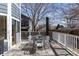 Outdoor deck with dining table, gray decking, white railings, and space for outdoor entertaining at 11722 W Belmont Pl, Littleton, CO 80127
