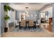 Open-concept dining room features modern lighting, neutral paint, and large windows at 11722 W Belmont Pl, Littleton, CO 80127
