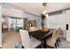 Spacious dining area features a stylish table, pendant lighting, and adjoins a versatile playroom at 11722 W Belmont Pl, Littleton, CO 80127