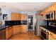 Updated kitchen boasts wood cabinets, stainless steel appliances, and granite countertops at 11722 W Belmont Pl, Littleton, CO 80127