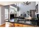 Stylish kitchen featuring black granite counters, stainless appliances, and an open view to the living space at 11722 W Belmont Pl, Littleton, CO 80127