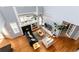 Open-concept living room with tall ceilings, fireplace, hardwood floors, and large windows for natural light at 11722 W Belmont Pl, Littleton, CO 80127