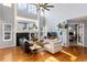 Spacious living room with hardwood floors, fireplace, and large windows at 11722 W Belmont Pl, Littleton, CO 80127