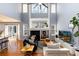 Bright living room with high ceilings, a cozy fireplace, and plenty of natural light, great for gatherings at 11722 W Belmont Pl, Littleton, CO 80127