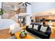 Bright living room boasts an open floor plan, staircase to the upper level, and hardwood floors at 11722 W Belmont Pl, Littleton, CO 80127