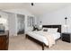 Main bedroom features a dark wood bed frame, neutral walls, and an ensuite bathroom at 11722 W Belmont Pl, Littleton, CO 80127