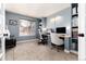 Bright office space with built-in bookshelves, carpeted floors, and natural light from a large window at 11722 W Belmont Pl, Littleton, CO 80127