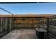 Small fenced back patio with concrete pad, wooden fence, partial overhead covering, and visible air conditioner at 1791 Quail St, Lakewood, CO 80215