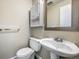 A half bath features a toilet, pedestal sink, medicine cabinet, and towel rack at 1791 Quail St, Lakewood, CO 80215