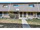Brick townhome featuring a mature bush and pathway to the front door at 1791 Quail St, Lakewood, CO 80215