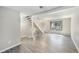 Open-concept living room boasts new flooring, staircase and large window at 1791 Quail St, Lakewood, CO 80215