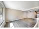 Spacious living room featuring new flooring and a large window letting in natural light at 1791 Quail St, Lakewood, CO 80215