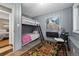 Unique bedroom featuring cozy bunk beds, complemented by stylish decor and a bright window at 34788 Forest Estates Rd, Evergreen, CO 80439