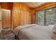 Bedroom showcasing wood accents, a sliding door to the outdoor deck, and closet space at 34788 Forest Estates Rd, Evergreen, CO 80439