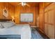 Bedroom features wooden walls, plush rug, and a serene, rustic ambiance at 34788 Forest Estates Rd, Evergreen, CO 80439