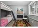 Unique bedroom featuring cozy bunk beds, complemented by stylish decor and a bright window at 34788 Forest Estates Rd, Evergreen, CO 80439