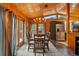 Dining area featuring wood accents, modern lighting, stainless steel appliances, and access to an outdoor deck at 34788 Forest Estates Rd, Evergreen, CO 80439