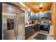 Modern kitchen with stainless steel appliances, sleek gray cabinets, and a cozy breakfast nook at 34788 Forest Estates Rd, Evergreen, CO 80439