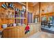 Charming kitchen area with wood accents, open shelving, and a view to the dining room at 34788 Forest Estates Rd, Evergreen, CO 80439