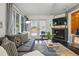Inviting living room featuring a fireplace, and sliding glass door offering backyard views at 34788 Forest Estates Rd, Evergreen, CO 80439