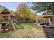 Fenced backyard featuring a playset, wood fence, and covered patio at 8510 Union Cir, Arvada, CO 80005