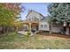 Charming home featuring a cozy backyard with a wooden deck, a pergola, and a well-maintained lawn at 8510 Union Cir, Arvada, CO 80005