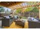 Inviting backyard patio with overhead pergola, stylish wicker furniture, and a view of the lush, landscaped yard at 8510 Union Cir, Arvada, CO 80005