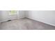 Neutral bedroom featuring gray carpet and trim, plus bright natural light from window at 8510 Union Cir, Arvada, CO 80005