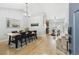 Open-concept dining area featuring hardwood floors, a table with six chairs, and seamless connection to the kitchen at 8510 Union Cir, Arvada, CO 80005