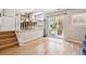 Open-concept living area boasts hardwood floors, access to kitchen, and a sliding glass door to outdoor space at 8510 Union Cir, Arvada, CO 80005