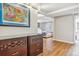 Bright basement hallway with wood-look floors and access to bedroom at 2916 Ivanhoe St, Denver, CO 80207