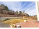 A tiered backyard featuring a large retaining wall, privacy fence, and a spacious patio at 9703 Ogden Ct, Thornton, CO 80229