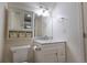 Bright bathroom featuring a white vanity with a marble countertop and mirrored medicine cabinet at 9703 Ogden Ct, Thornton, CO 80229