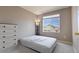 Bedroom with carpet, dresser and a window view of the neighborhood at 9703 Ogden Ct, Thornton, CO 80229