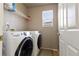 Laundry room with newer washer and dryer, cabinets and utility sink at 9703 Ogden Ct, Thornton, CO 80229