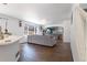 Comfortable living room featuring tiled floors, a plush sofa, and a large window at 9703 Ogden Ct, Thornton, CO 80229