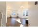 Open living room features tiled floors, vaulted ceiling, and abundant light from two bay windows at 9703 Ogden Ct, Thornton, CO 80229