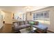 Bright living room boasts wood floors, large windows, open layout to kitchen and dining areas at 9703 Ogden Ct, Thornton, CO 80229