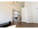 Bright living room with tiled floors, vaulted ceiling, and an adjacent staircase at 9703 Ogden Ct, Thornton, CO 80229